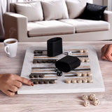 Backgammon game in progress on a marble board with dice and pieces, in a living room setting.