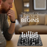 Man playing chess with text 'The Game of Patience Begins' in a living room setting.