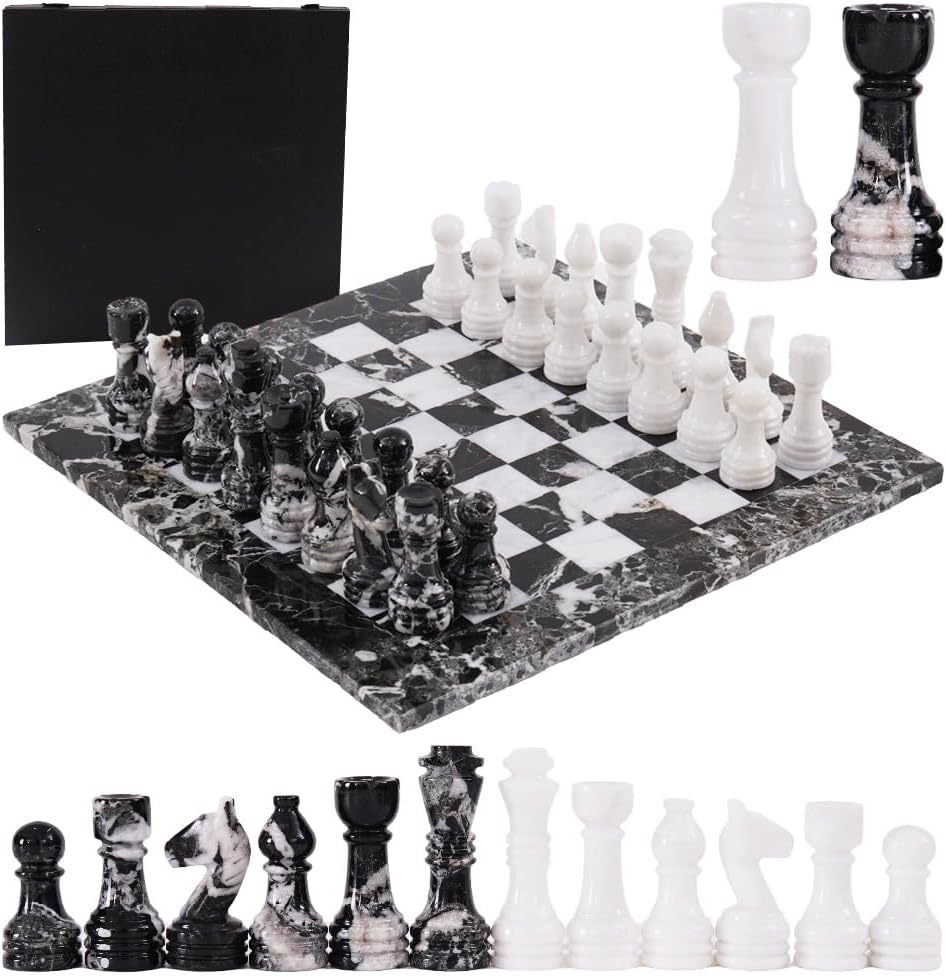 Marble-patterned chessboard with black and white chess pieces on a white background