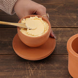 Terracotta Butter Keeper with Butter on a wooden table
