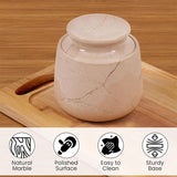 Marble-patterned container on a wooden surface with product features listed below.