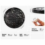 Black marble round gaming board with white marble veining, shown with dimension callouts indicating 10 inches diameter and 1 inch height, alongside a close-up of a hand holding a white marble ball and text noting 42 balls are included.