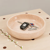 Natural marble bowl used for keys and everyday essentials.