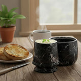 Black marble butter keeper on a breakfast table with toast and coffee.