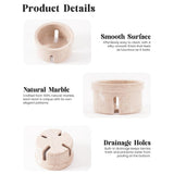 Marble berry bowls with drainage holes on a white background