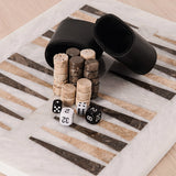Black dice cups with wooden dice and dice on a striped surface