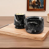 Black marble butter keeper set displayed on a wooden board.