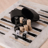Marble-patterned board with black and white dice, dice cups.