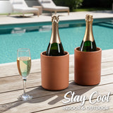 Two bottles of champagne in terracotta coolers with a glass on a wooden deck by a pool, with 'Stay Cool Indoor & Outdoor' text.