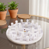 Marble Mind Game with Dice on a reflective surface, with potted plants in the background.