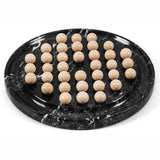 A set of 36 polished beige stone playing balls arranged on black marble game board with white veining, photographed on a clean white background.