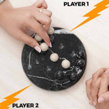 Two hands interacting with a marble game board labeled 'Player 1' and 'Player 2'.