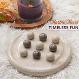 Marble moves game on a stone tray with flowers and a candle in the background