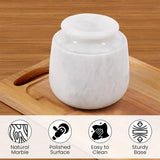 White marble-patterned container on a wooden surface with icons and text describing features.