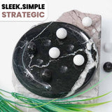 Black marble game board with white and black balls on a light background, featuring the text 'Sleek.Simple.Strategic'.