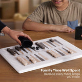 Two people playing backgammon with a child sitting at a table, text 'Family Time Well Spent'.