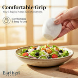 A hand holds a white shaker over a salad bowl on a wooden table, with text reading 'Comfortable Grip' and 'Easy to dispense multiple types of condiments. Comfortable & Easy To Use.