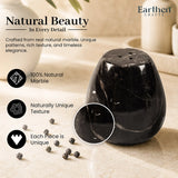 A polished black marble salt and pepper shaker 