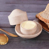 Marble butter crock with spreadable butter being served during breakfast.