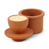 Terracotta butter keeper with a lid inside on a white background