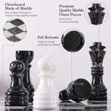Marble chessboard with black and white pieces on a light background