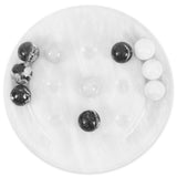 Round white tic tac toe with black and white marbled balls arranged in a circular pattern.