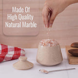 Marble salt grinder on a kitchen counter with text 'Made Of High Quality Natural Marble'.