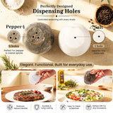 A pair of marble seasoning shakers, showing one pepper shaker and one salt shaker on a beige textured background. The top text highlights the dispensing holes, and the bottom features lifestyle panels of hands seasoning a steak and a salad, with feature icons at the bottom.