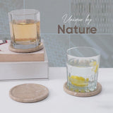 Two glasses with lemon slices on marble coasters, with 'Unique by Nature' text.
