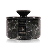 Black marble-patterned container with a lid on a white background
