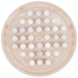 Round beige board with white balls on a white background