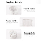 Handcrafted white marble berry bowl with footed base and side drainage openings, empty