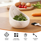 Marble herb holder with fresh herbs on a wooden surface with vegetables in the background