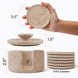 Set of stone coasters with dimensions and a hand holding one coaster.