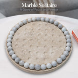 Marble Solitaire game with marble stones on a concrete base