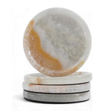 Set of four marble-patterned coasters on a white background