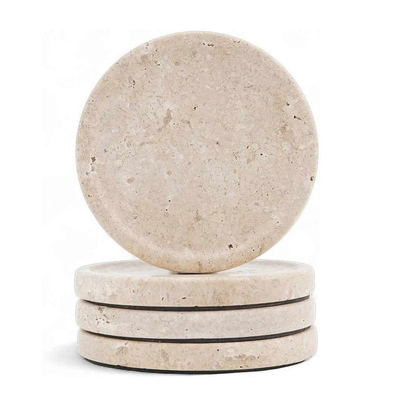 Set of four travertine stone coasters on a white background