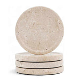 Set of four travertine stone coasters on a white background
