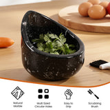 Black marble herb container with cilantro on a wooden surface, surrounded by vegetables and a scrubbing brush.
