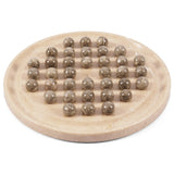 A round beige stone game board with multiple small polished oceanic  balls arranged on it, photographed on a clean white background.