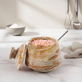 Marbled jar with pink Himalayan salt on a marble surface, branded 'Earthen Crafts'.