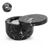Black marble container with lid on a white background