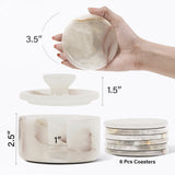 Set of marble coasters with dimensions and a hand holding one coaster.