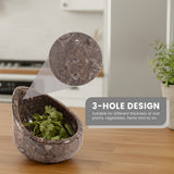 Decorative stone peeler with herbs on a wooden surface, showing a 3-hole design feature.