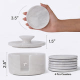 White marble coaster set with dimensions and a hand holding a coaster.