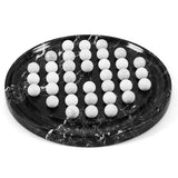 A black marble board with white balls marble veining, holding 32 white polished spherical beads arranged in rows, on a clean white background.
