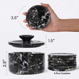 Black marble coaster set with dimensions and a hand holding one coaster.