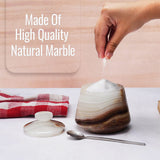 Marble-patterned salt shaker on a kitchen counter with text 'Made Of High Quality Natural Marble'.