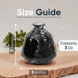 Black marbled container with measurements and capacity details on a wooden surface.