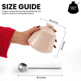A marble  jar with a lid, shown being held by a hand wearing a red sweater. The image includes size annotations indicating the jar is 4 inches tall and the accompanying metal spoon is 5 inches long, with text describing its space-saving size and a small capacity badge reading 9.